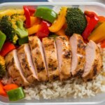 Healthy chicken and rice meal prep bowls with sliced chicken breast, rice, and colorful vegetables in meal prep containers