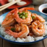 Honey garlic shrimp cooked in a skillet with a glossy sauce