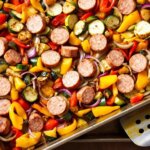 sheet pan sausage and vegetables roasted with bell peppers, zucchini, and red onion
